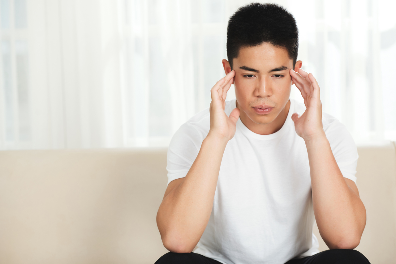 A young man having headaches