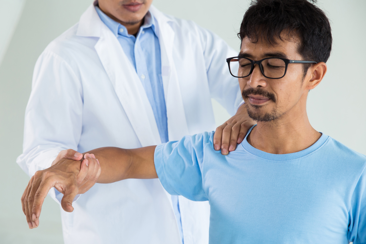 A chiropractor examining a patient's condition