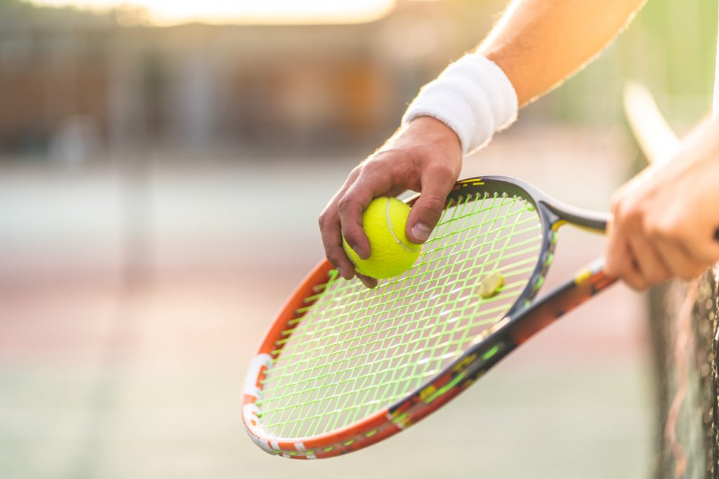Close up of a tennis athlete about to serve