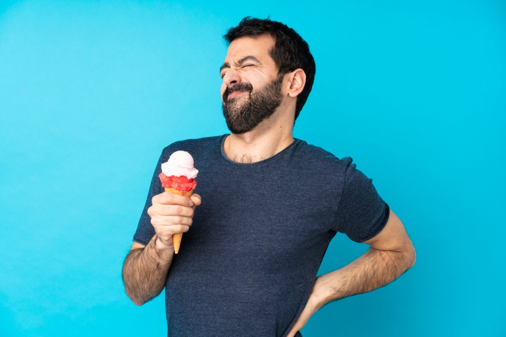 A man eating ice cream with back pain