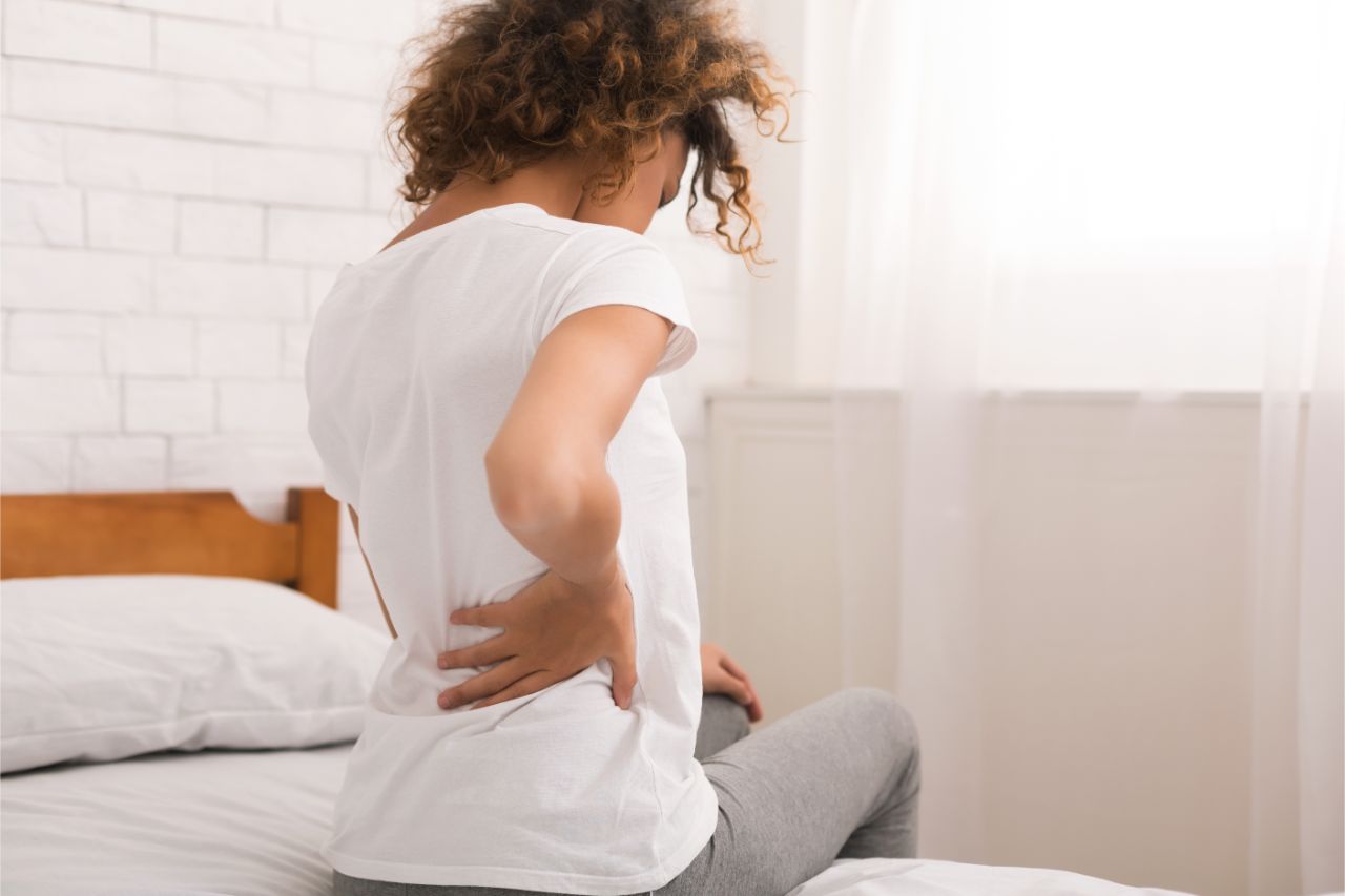 A woman experiencing back pain