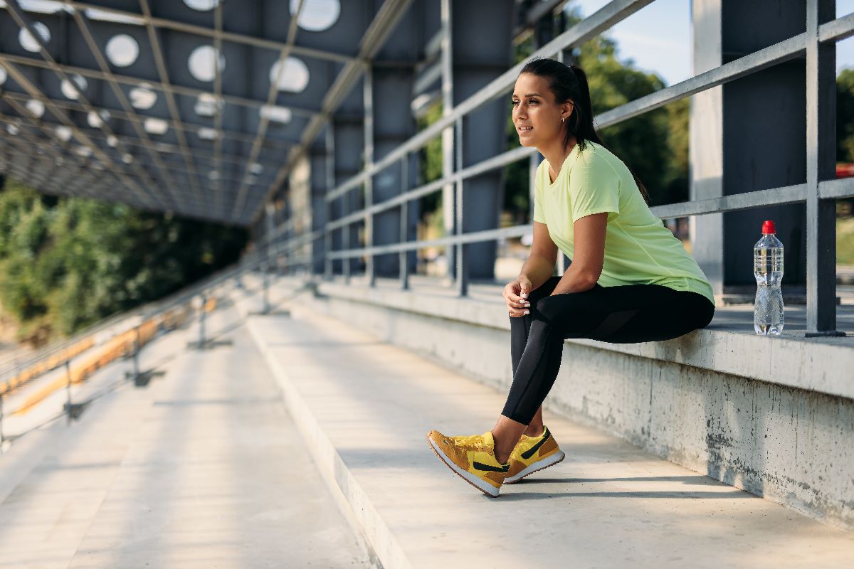 An athlete hydrating and resting after a workout
